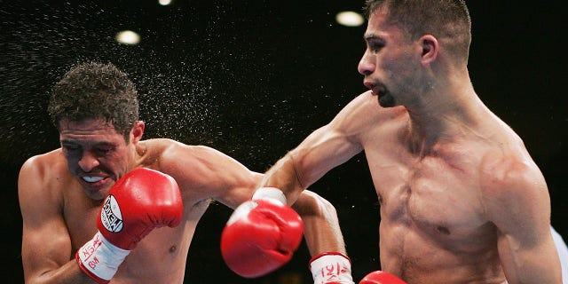 Nedal Hussein, right, connects with a right to the face of Oscar Larios during a fight for the WBC World Super Bantamweight Championship at the MGM Grand Garden Arena on Nov. 27, 2004 in Las Vegas. Larios defeated Hussein by unanimous decision.