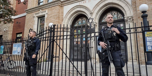 Hoboken Police officers stand watch outside the United Synagogue of Hoboken, Thursday, Nov. 3, 2022, in Hoboken, N.J.