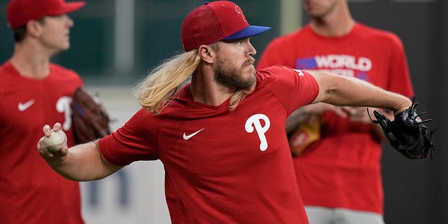 The Philadelphia Phillies' Noah Syndergaard warms up during batting practice before Game 1 of the World Series against the Houston Astros Friday, Oct. 28, 2022, in Houston. 