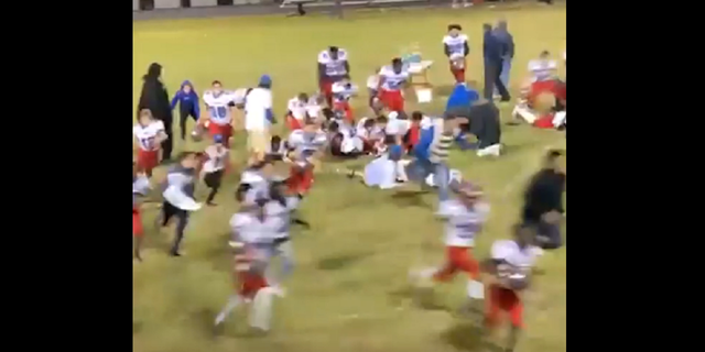 Footage shows a football team sprinting off the field at Lumberton High School in Lumberton, North Carolina, after hearing gunshots.