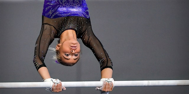 Apr 16, 2021; Fort Worth, Texas, USA; LSU Tigers freshman gymnast Olivia Dunne performs on the uneven bars during the 2021 NCAA Women Gymnastics Championships at Dickies Arena.