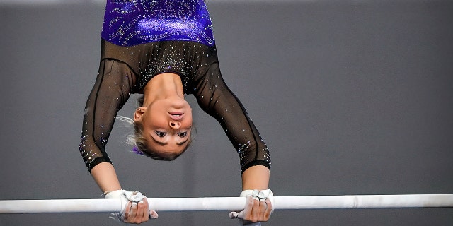 Apr 16, 2021; Fort Worth, Texas, USA; LSU Tigers freshman gymnast Olivia Dunne performs on the uneven bars during the 2021 NCAA Women Gymnastics Championships at Dickies Arena.