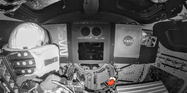 Snoopy, the zero-gravity indicator for NASA's Artemis I flight test, floats into space on Nov. 20, 2022, while attached to its tether aboard the Orion spacecraft.  In this enlarged image, Snoopy stands in a custom orange spacesuit, while Orion's interior is shaded black and white for contrast.  The character's spacesuit is modeled after the suits astronauts would wear during launch and re-entry in Orion on future missions to the Moon.  NASA has shared an association with Charles M. Schulz and Snoopy since the Apollo missions, and the relationship continues under Artemis.  Snoopy was chosen as the zero-gravity symbol for the flight because the character has provided inspiration and enthusiasm for human spaceflight for more than 50 years.
