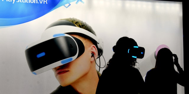 L'HOSPITALET, BARCELONA, SPAIN - 2018/11/30: A young woman prepares to play with virtual reality glasses on a playground at the Barcelona Games World Fair. 