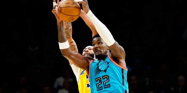 Phoenix Suns' Deandre Ayton, #22, out jumps Los Angeles Lakers' Anthony Davis for the ball during the first half of an NBA basketball game in Phoenix, Tuesday, Nov. 22, 2022.