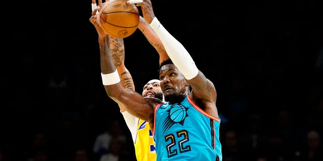 Phoenix Suns' Deandre Ayton, #22, out jumps Los Angeles Lakers' Anthony Davis for the ball during the first half of an NBA basketball game in Phoenix, Tuesday, Nov. 22, 2022. 