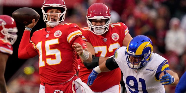 Kansas City Chiefs quarterback Patrick Mahomes (15) throws a pass while being pressured by Los Angeles Rams defensive tackle Greg Gaines (91) during the first half of an NFL football game on Sunday, November 27, 2022 in Kansas City, Missouri.