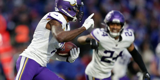 Minnesota Vikings cornerback Patrick Peterson (7) runs with the ball after incepting a pass by Buffalo Bills quarterback Josh Allen as safety Camryn Bynum (24) looks on in overtime of an NFL football game, Sunday, Nov. 13, 2022, in Orchard Park, N.Y. 