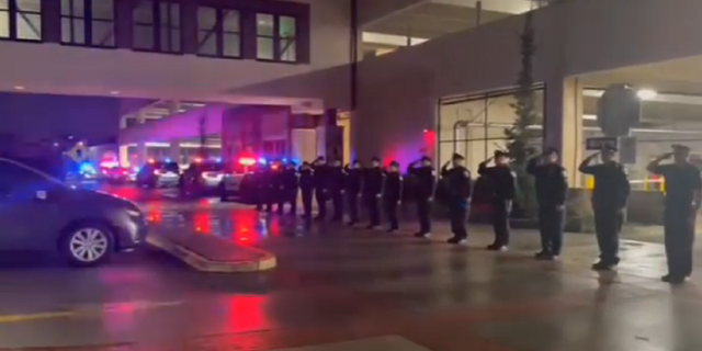 Officers line up to salute the late Bayonne Police Capt. Paul Jamolawicz.