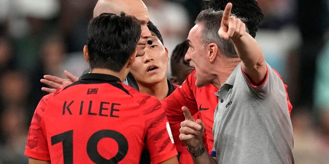 Referee Anthony Taylor, left, listens to South Korea's head coach Paulo Bento, right, after the World Cup Group H soccer match between South Korea and Ghana, at the Education City Stadium in Al Rayyan, Qatar, Monday, Nov. 28, 2022.