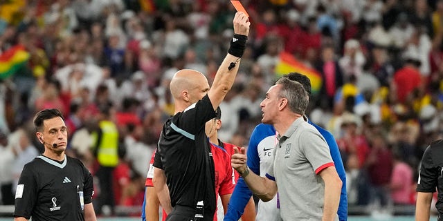 Referee Anthony Taylor shows the red card to South Korea's head coach Paulo Bento after the World Cup Group H soccer match between South Korea and Ghana, at the Education City Stadium in Al Rayyan, Qatar, Monday, Nov. 28, 2022.