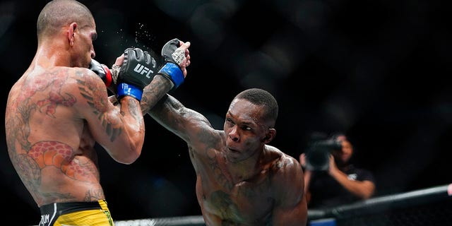 Israel Adesanya punches Alex Pereira at the UFC 281 mixed martial arts event, Nov. 13, 2022, in New York.