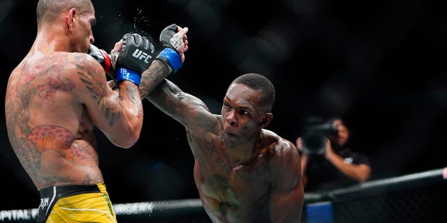 Israel Adesanya punches Alex Pereira at the UFC 281 mixed martial arts event, Nov. 13, 2022, in New York.