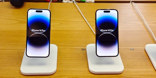 Customers experience the new iPhone 14 series smartphones at the Apple Inc flagship store in Shanghai, China, Oct 13, 2022.