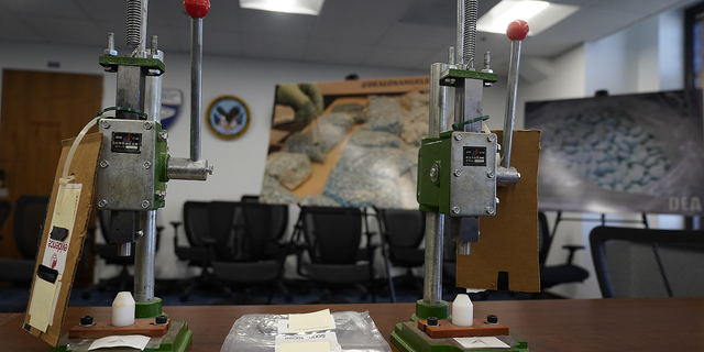 A pair of manual pill presses used to mass-produce fake fentanyl-containing pills that are sold on the dark web and through distributors operating openly on social media sites are on display at the Central District of California offices of the Office of the US Attorney in Los Angeles on November 21.