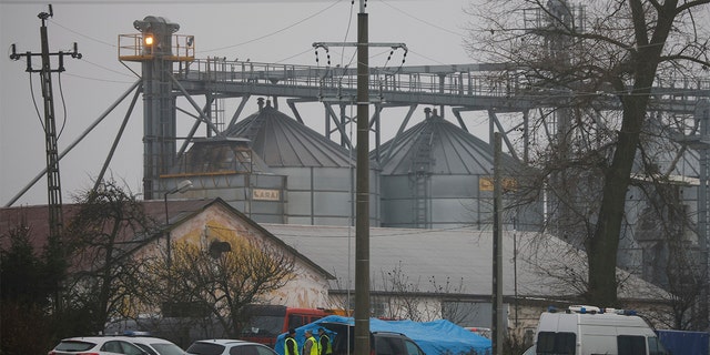 Police officers work outside a grain depot where, according to the Polish government, an explosion of a Russian-made missile killed two people in Przewodow, Poland, Wednesday, Nov. 16, 2022. Poland said Wednesday that a Russian-made missile fell in the country’s east, killing two people, though President Biden said it was "unlikely" it was fired from Russia.