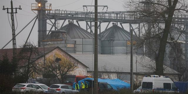 Police officers work outside a grain depot where, according to the Polish government, the explosion of a Russian-made missile killed two people in Przewodow, Poland on Wednesday, Nov. 16, 2022. Poland said on Wednesday that a missile made in Russia fell on the east of the country, killing two people, even though President Biden said it was "unlikely" was fired by Russia.