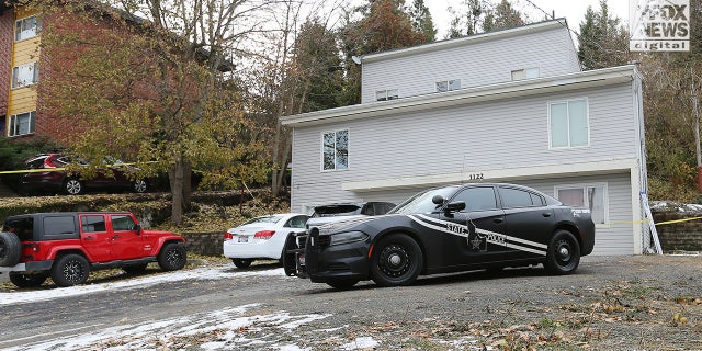 Police vehicles at the scene of the quadruple homicide in Idaho.