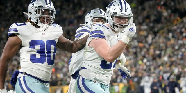 Dallas Cowboys' Qadree Ollison, #30, Luke Gifford, #57, and C.J. Goodwin, rear, celebrate after making a stop on a Green Bay Packers punt return during the second half of an NFL football game Sunday, Nov. 13, 2022, in Green Bay, Wisconsin.