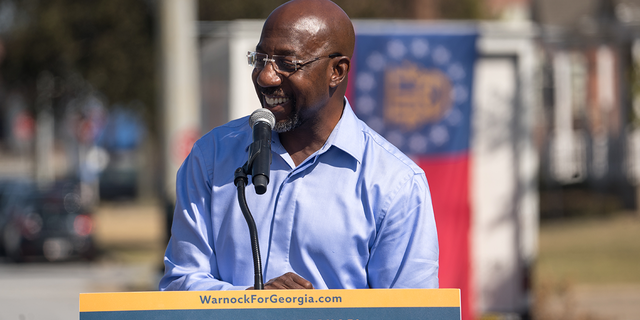 Senator Rev. Raphael Warnock speaks to supporters during his campaign tour, outside of the Liberty Theater on October 8, 2022 in Columbus, Georgia. Warnock is running for re-election against Republican candidate Herschel Walker.