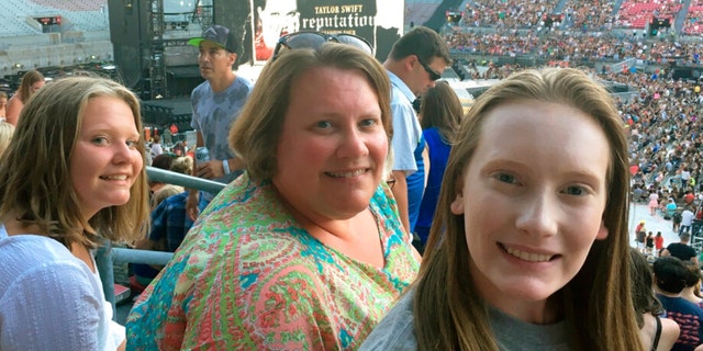 Natasha Mitchner, shown attending a Taylor Swift concert in Columbus, Ohio, with her daughters on July 7, 2018, scored tickets to a Swift concert after several hours in the Ticketmaster queue.
