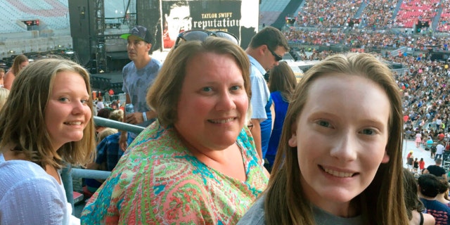 Natasha Mitchner, shown attending a Taylor Swift concert in Columbus, Ohio, with her daughters on July 7, 2018, scored tickets to a Swift concert after several hours in the Ticketmaster queue.