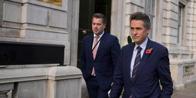 British MP Gavin Williamson (right), a former minister of state without portfolio, leaves the cabinet in London.  31, 2022. 