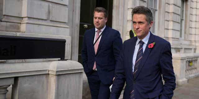 British lawmaker Gavin Williamson, right, a former minister of state without portfolio, leaves the Cabinet Office in London on October 31, 2022.