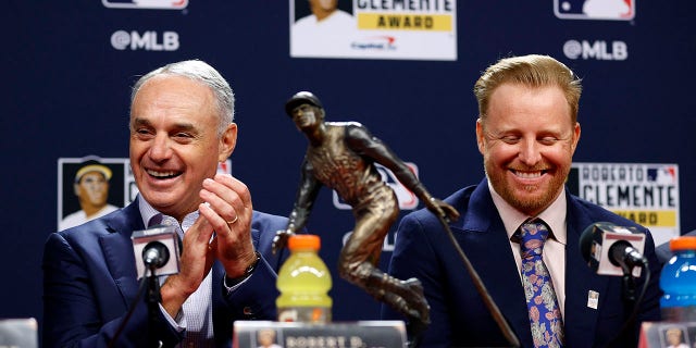 Commissioner of Baseball Robert D. Manfred Jr. and Roberto Clemente Award winner Justin Turner of the Los Angeles Dodgers speak to the media prior to Game Three of the 2022 World Series at Citizens Bank Park on October 31, 2022 in Philadelphia, Pennsylvania
