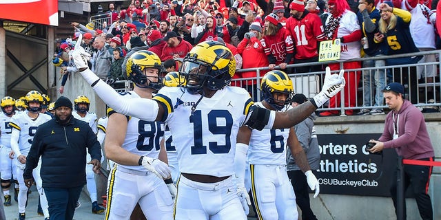 Rod Moore (19) of the Michigan Wolverines walks onto the field with his team before a game against the Ohio State Buckeyes at Ohio Stadium Nov. 26, 2022, in Columbus, Ohio.