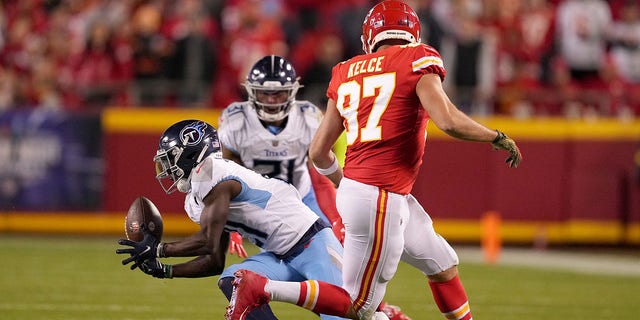 Roger McCreary #21 of the Tennessee Titans intercepts a pass intended for Travis Kelce #87 of the Kansas City Chiefs in the second half at Arrowhead Stadium on November 06, 2022 in Kansas City, Missouri.