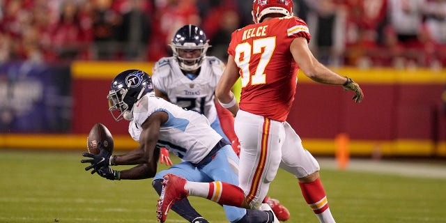 Roger McCreary #21 of the Tennessee Titans intercepts a pass intended for Travis Kelce #87 of the Kansas City Chiefs in the second half at Arrowhead Stadium on November 06, 2022 in Kansas City, Missouri.