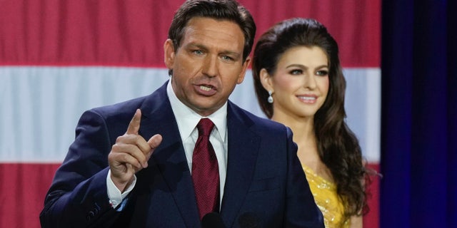 Incumbent Florida Republican Gov. Ron DeSantis speaks to supporters at an election night party after winning his race for reelection in Tampa, Fla., Tuesday, Nov. 8, 2022, as his wife Casey listens.