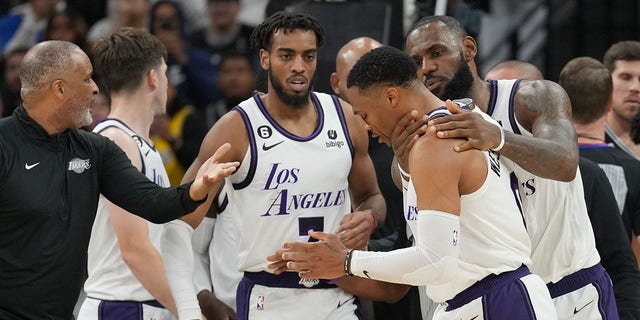 Los Angeles Lakers forward LeBron James holds guard Russell Westbrook after Westbrook was fouled by Spurs forward Zach Collins on Nov. 26, 2022, in San Antonio, Texas.