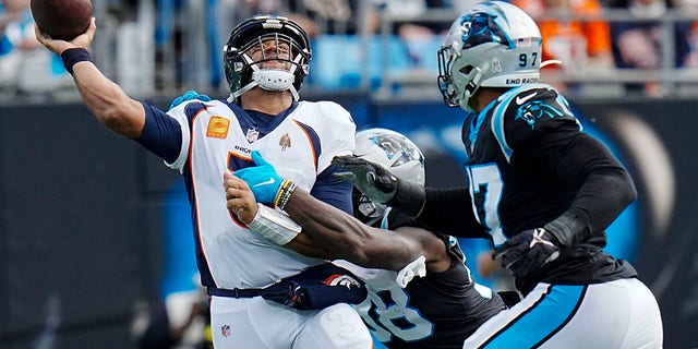 Denver Broncos quarterback Russell Wilson is sacked on Sunday, Nov. 27, 2022, in Charlotte, North Carolina.