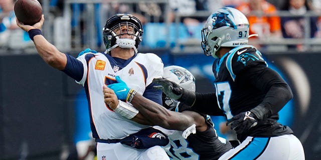 Denver Broncos quarterback Russell Wilson is sacked on Sunday, Nov. 27, 2022, in Charlotte, North Carolina.