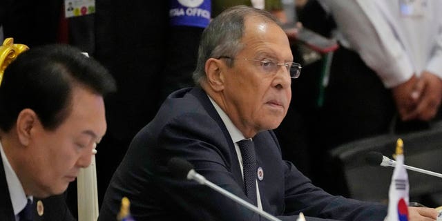 Sitting next to South Korea President Yoon Suk Yeol, left, Russian Foreign Minister Sergey Lavrov listens during the ASEAN Australia-New Zealand Trade Area in Phnom Penh, Cambodia on Nov. 13, 2022.