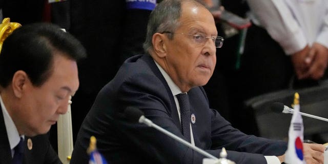 Sitting next to South Korea President Yoon Suk Yeol, left, Russian Foreign Minister Sergey Lavrov listens during the ASEAN Australia-New Zealand Trade Area in Phnom Penh, Cambodia on Nov. 13, 2022.