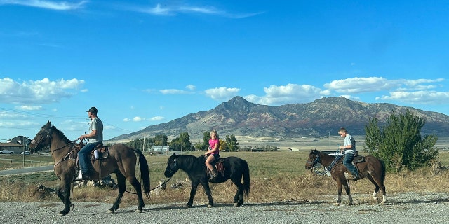 Shane Adams rides Mongo, as his kids follow behind on the family ponies.