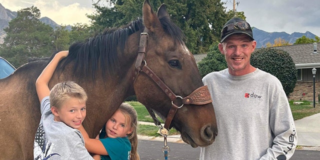 Shane Adams poses with Mongo, along with his children, Owen and Anna.