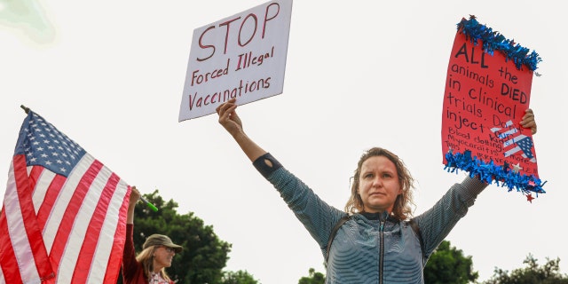 SAN DIEGO, CA - SEPTEMBER 28: Anti-vaccine protesters stage a protest outside the San Diego Unified School District office to protest a forced vaccination mandate for students on September 28, 2021, in San Diego, California. 