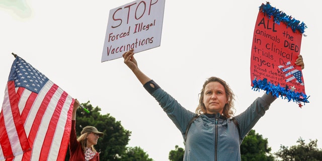 SAN DIEGO, CA - SEPTEMBER 28: Anti-vaccine protesters stage a protest outside the San Diego Unified School District office to protest the mandatory vaccination mandate for students on September 28, 2021 in San Diego, California. 