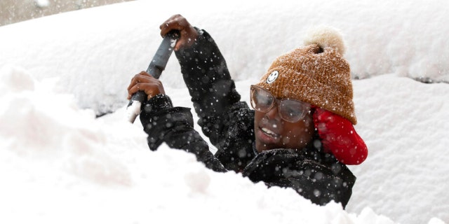 Zaria Black, 24, of Buffalo, clears off her
car as snow falls on Friday, Nov. 18, 2022, in
Buffalo, New York. It is better to buy items now
(and potentially not need them) than to need
them and not have them, say safety experts