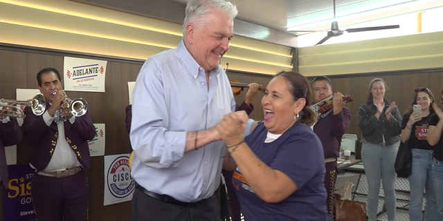 Nevada Gov. Steve Sisolak dances with a voter at a Get Out The Vote Rally on Oct. 22, 2022.