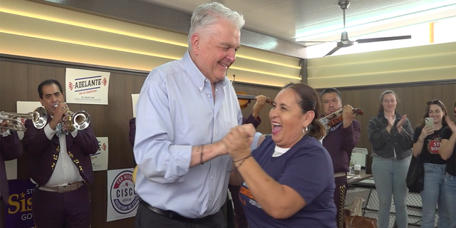 Nevada Gov. Steve Sisolak dances with a voter at a Get Out The Vote Rally on Oct. 22, 2022.