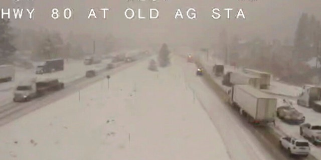 In this image taken from video from a Caltrans remote video traffic camera, traffic moves slowly through the snowy conditions along Interstate 80 near Truckee, Calif., Tuesday, Nov. 8, 2022. 