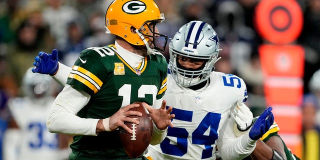 Sam Williams (54) of the Dallas Cowboys sacks Aaron Rodgers (12) of the Green Bay Packers during the third quarter at Lambeau Field Nov. 13, 2022 in Green Bay, Wis.