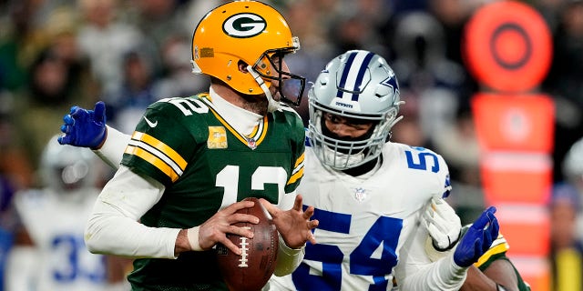 Sam Williams (54) of the Dallas Cowboys sacks Aaron Rodgers (12) of the Green Bay Packers during the third quarter at Lambeau Field Nov. 13, 2022 in Green Bay, Wis.