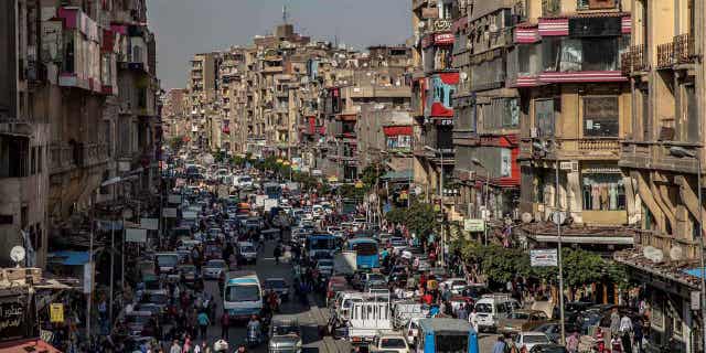 People crowd a street a few hours ahead of curfew in Cairo, Egypt, on April 14, 2020. Saudi Arabia agreed on Nov. 29, 2022, to extend the terms of a $5 billion aid package to Egypt in March.