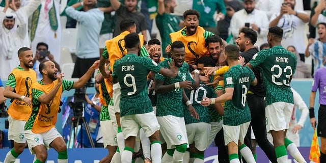 Saudi Arabia's Salem Al-Dawsari is congratulated after scoring his side's second goal during a World Cup Group C match against Argentina at the Lusail Stadium in Lusail, Qatar, Tuesday, Nov. 22, 2022. 